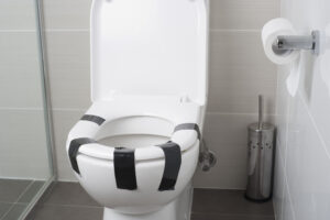 Toilet seat taped down with duct tape